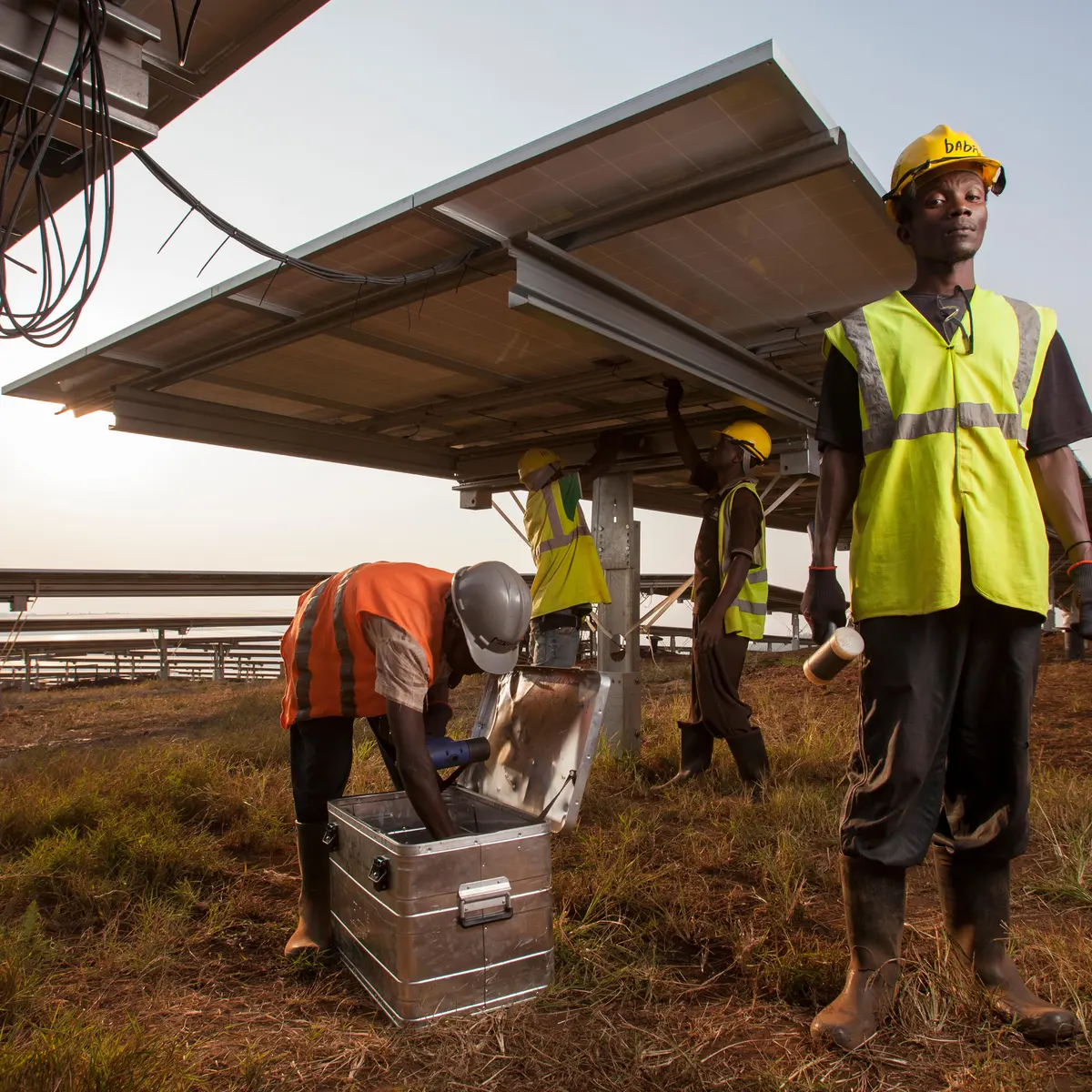 Installation crew mounting solar panels at sunrise